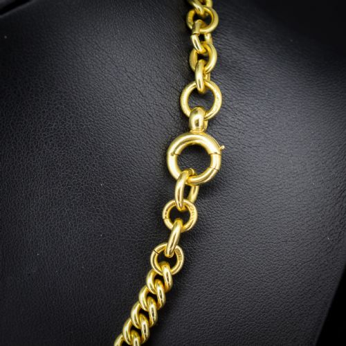 fig 3. An 18ct yellow gold curb link Albert chain necklace featuring a central ring with a T-bar drop, displayed on a black jewellery bust.