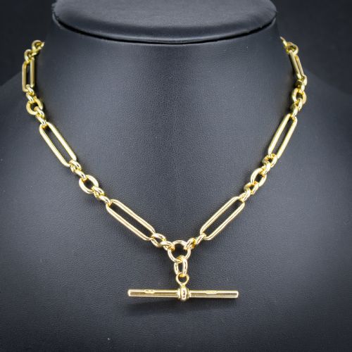 fig 1. An antique 18ct yellow gold trombone link watch chain featuring an integrated T-bar and swivel clasp fastener.