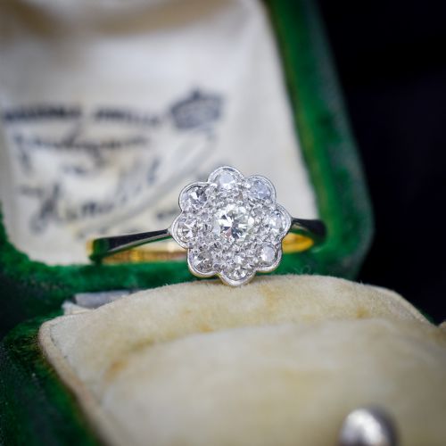 fig 1. An antique diamond cluster ring arranged in a floral daisy pattern, set in platinum with an 18ct yellow gold band.