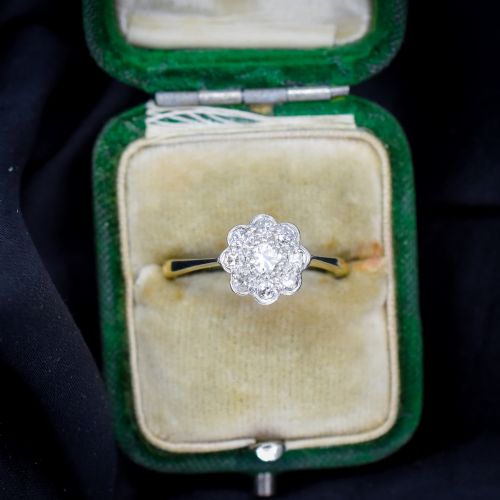 fig 2. An antique diamond cluster ring arranged in a floral daisy pattern, set in platinum with an 18ct yellow gold band.