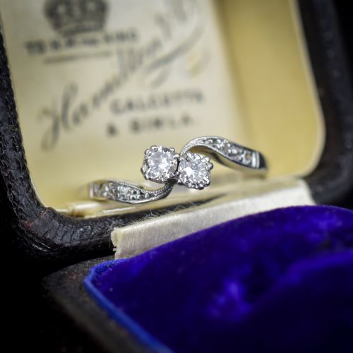 fig 1. An antique 18ct white gold Toi et Moi ring featuring two central round diamonds set in a diagonal twist arrangement with diamond-set shoulders.
