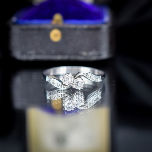 fig 2. An antique 18ct white gold Toi et Moi ring featuring two central round diamonds set in a diagonal twist arrangement with diamond-set shoulders.