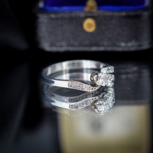 fig 3. An antique 18ct white gold Toi et Moi ring featuring two central round diamonds set in a diagonal twist arrangement with diamond-set shoulders.