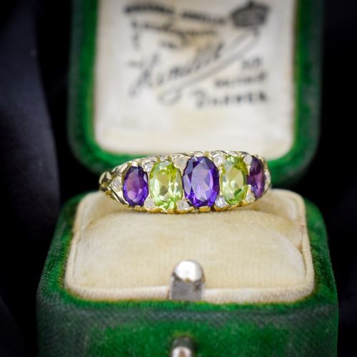 fig 2. An antique 18ct yellow gold five-stone ring featuring alternating oval amethysts and peridots set with small diamond accents in a carved gallery.