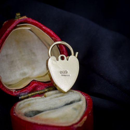fig 1. A 9ct yellow gold heart-shaped padlock charm featuring hand-engraved scrollwork and a keyhole detail.