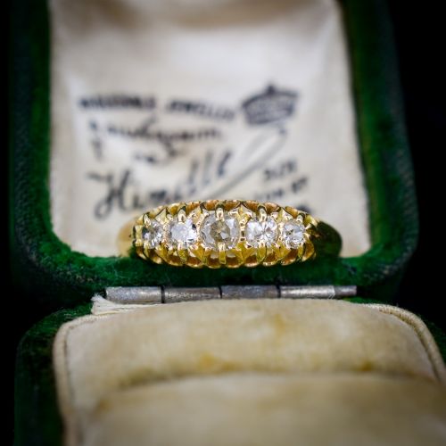 fig 1. An 18ct yellow gold five-stone ring set with old cut diamonds in a carved scrollwork gallery.