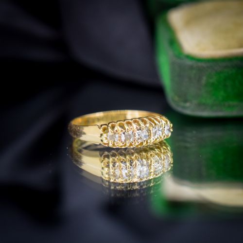 fig 2. An 18ct yellow gold five-stone ring set with old cut diamonds in a carved scrollwork gallery.