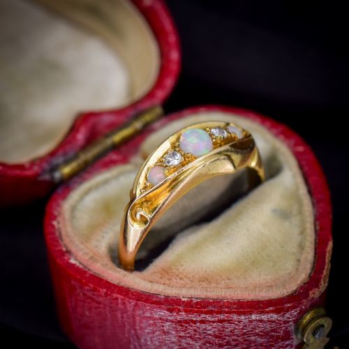fig 2. An antique 18ct yellow gold boat setting ring featuring three cabochon opals and two small diamonds.