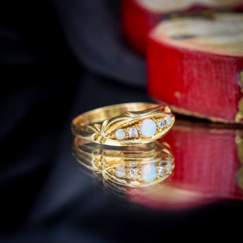 fig 3. An antique 18ct yellow gold boat setting ring featuring three cabochon opals and two small diamonds.