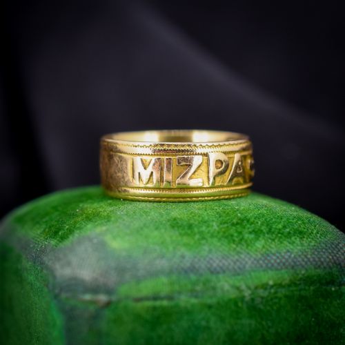 fig 1. An antique 18ct yellow gold wide band ring featuring the word MIZPAH in raised relief lettering bordered by beaded detailing.