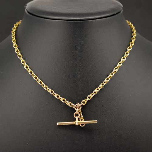 fig 1. An antique 9ct gold double Albert watch chain featuring love knot links, two swivel clasps, and a central T-bar.