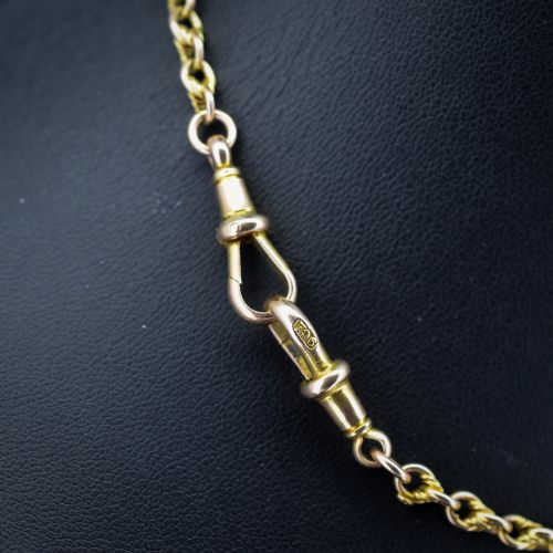 fig 2. An antique 9ct gold double Albert watch chain featuring love knot links, two swivel clasps, and a central T-bar.