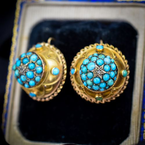 fig 1. A pair of circular Victorian 9ct gold earrings featuring raised central domes set with pave turquoise cabochons and framed by decorative wirework.
