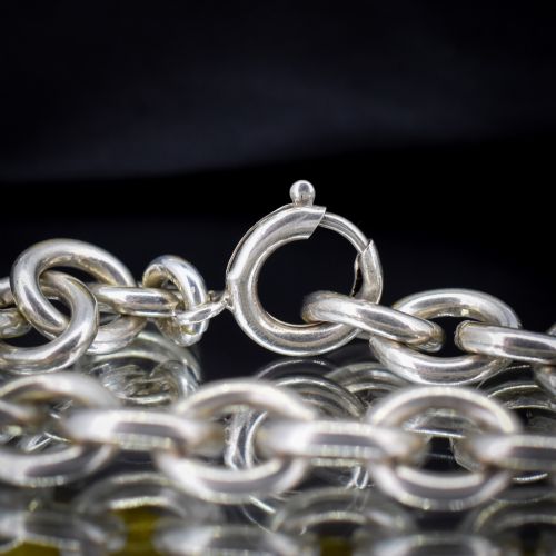 fig 2. A sterling silver link bracelet composed of interlocking oval cable links with a bolt ring clasp.