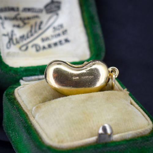 fig 2. A smooth, polished 9ct yellow gold bean-shaped charm with an attached suspension jump ring.