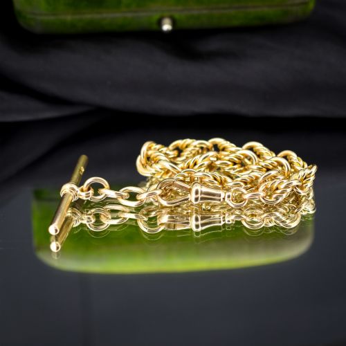 fig 2. An antique 9ct yellow gold love knot chain bracelet featuring a swivel clasp and suspended T-bar detail.