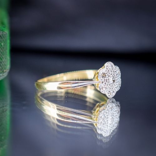 fig 2. An antique 18ct yellow gold ring featuring a floral diamond cluster head set in platinum.