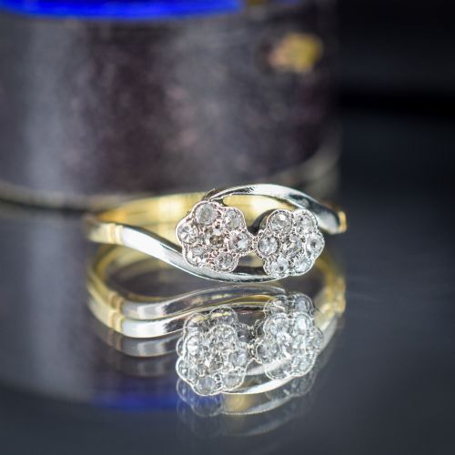 fig 1. An antique 18ct yellow gold crossover ring featuring two diamond cluster flowers set in white metal on sweeping twist shoulders.