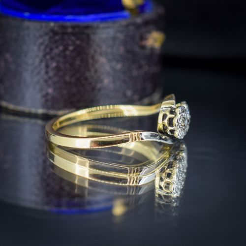 fig 2. An antique 18ct yellow gold crossover ring featuring two diamond cluster flowers set in white metal on sweeping twist shoulders.