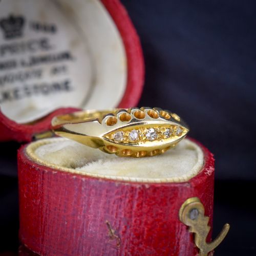 fig 1. An 18ct yellow gold boat ring set with five graduated diamonds within a carved pierced gallery.
