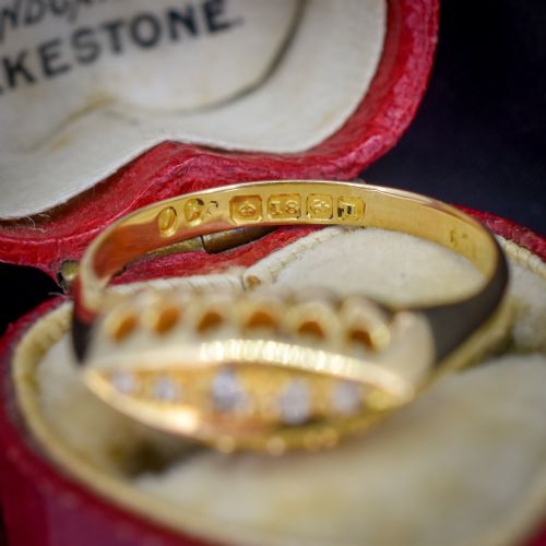 fig 2. An 18ct yellow gold boat ring set with five graduated diamonds within a carved pierced gallery.