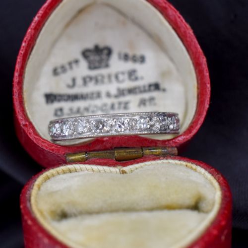 fig 2. An Art Deco palladium full eternity ring set with a continuous band of round diamonds bordered by milgrain edging.