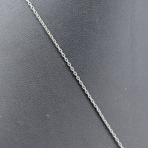fig 2. An Art Deco carved green jade pendant with geometric platinum and diamond accents on a chain.