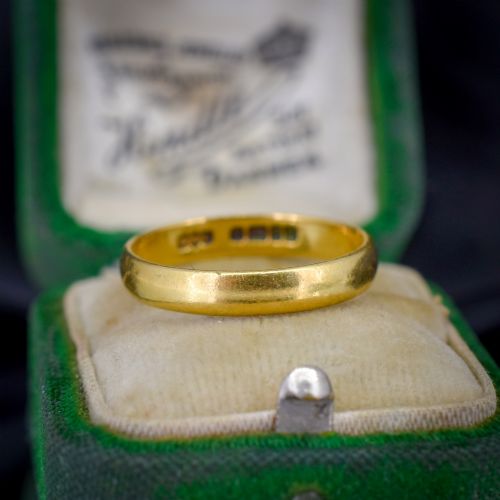 fig 1. A polished 22ct yellow gold plain wedding band displaying visible interior hallmarks.