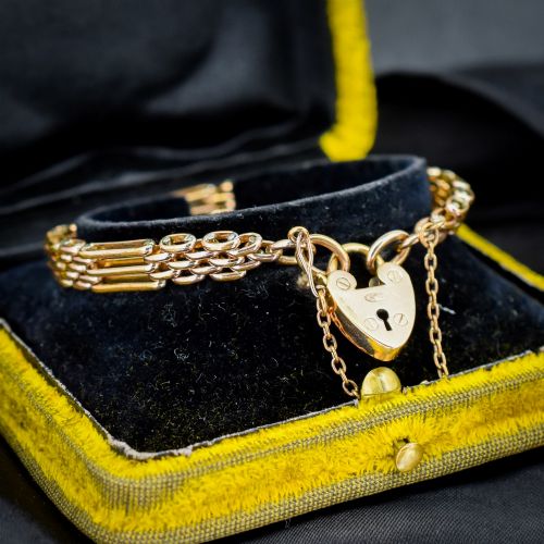 fig 1. An antique rolled gold gate link bracelet featuring an engraved heart-shaped padlock clasp and safety chain.