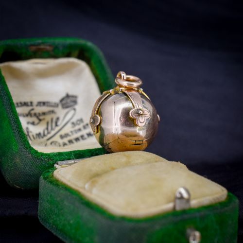 fig 1. An antique spherical gold and silver Masonic ball charm featuring four chased outer arms and a top bail for suspension.