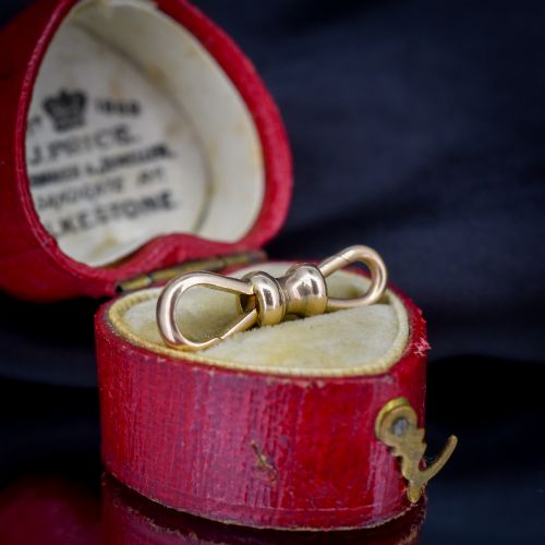 fig 1. A double-sided 9ct yellow gold antique dog clip clasp featuring hinged spring fasteners at both ends connected by a central barrel collar.