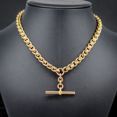 fig 1. An antique 9ct yellow gold rollerball Albert chain featuring a central T-bar drop and double dog clip clasps.