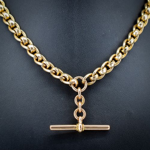 fig 2. An antique 9ct yellow gold rollerball Albert chain featuring a central T-bar drop and double dog clip clasps.