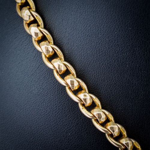 fig 3. An antique 9ct yellow gold rollerball Albert chain featuring a central T-bar drop and double dog clip clasps.