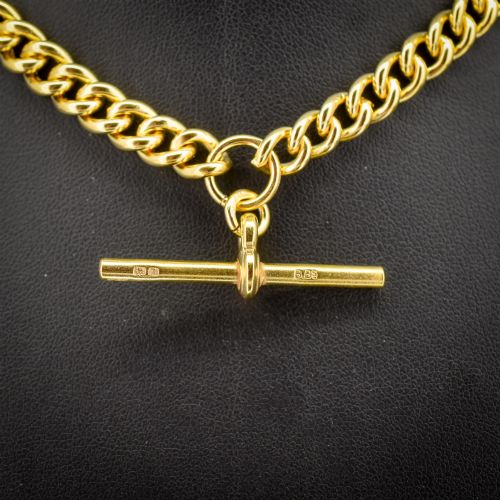 fig 2. An antique gold-gilded sterling silver Albert watch chain featuring uniform curb links, a T-bar attachment, and dual swivel clasps.