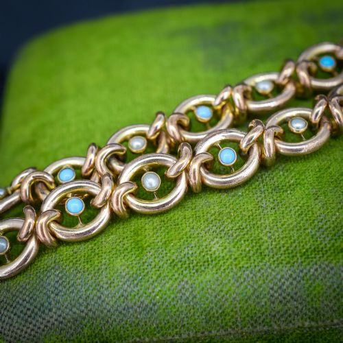 fig 2. An antique rolled gold chain bracelet inset with alternating seed pearls and turquoise cabochons, featuring a heart-shaped padlock clasp with safety chain.