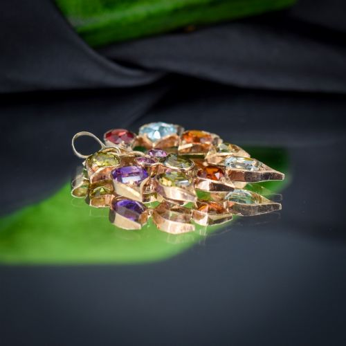 fig 1. An antique 9ct yellow gold floral drop pendant composed of leaf-shaped settings encasing various multi-coloured faceted gemstones.
