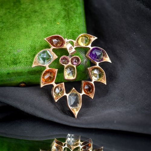 fig 2. An antique 9ct yellow gold floral drop pendant composed of leaf-shaped settings encasing various multi-coloured faceted gemstones.