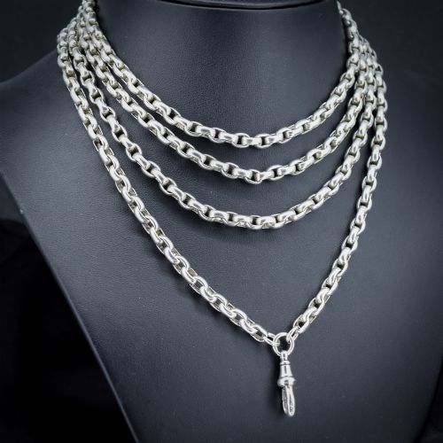 fig 1. An antique sterling silver long guard chain featuring belcher links and a dog clip clasp, wrapped in multiple layers on a display bust.