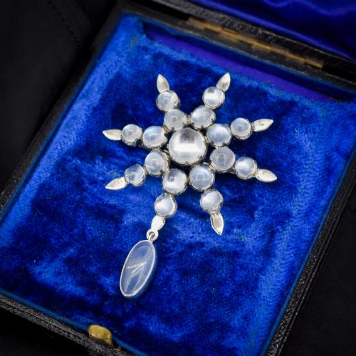 fig 1. A Victorian silver starburst brooch set with round cabochon moonstones and a suspended oval moonstone drop.