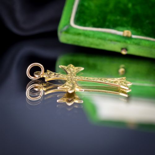 fig 2. An Edwardian 9ct yellow gold cross pendant with intricate foliate hand engraving and a top suspension ring.