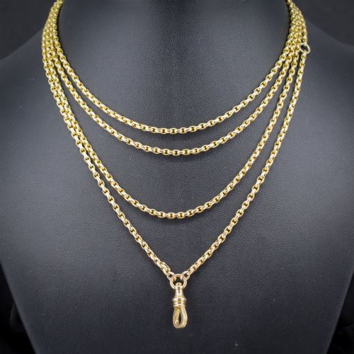 fig 1. An antique 10ct yellow gold long guard chain featuring faceted oval links and a dog clip fastener.