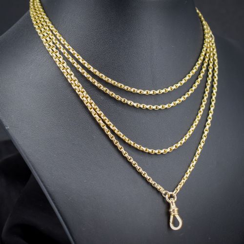 fig 2. An antique 10ct yellow gold long guard chain featuring faceted oval links and a dog clip fastener.