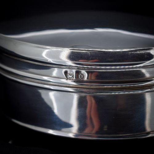 fig 1. An oval sterling silver trinket box with a smooth polished hinged lid supported on four small cabriole feet.