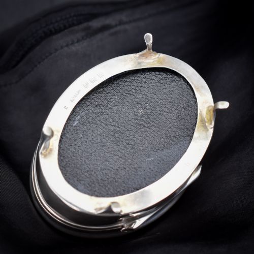 fig 2. An oval sterling silver trinket box with a smooth polished hinged lid supported on four small cabriole feet.