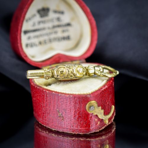 fig 1. An antique gold-cased pocket watch key pendant inset with a square red agate stone and decorated with intricate chased patterns.