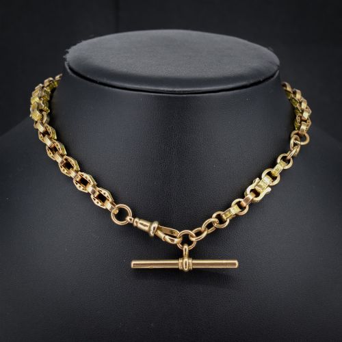 fig 1. An antique 9ct yellow gold Albert watch chain with star engraved fancy links, a central T-bar, and a swivel dog clip fastener.