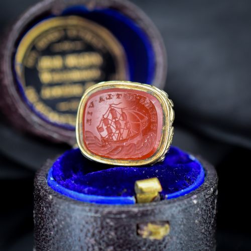 fig 1. A Georgian gold fob seal set with a red carnelian intaglio engraved with a sailing ship and the French inscription Telle Est La Vie.
