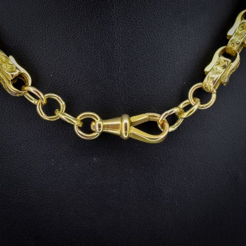 fig 1. An antique 10ct yellow gold tulip link chain necklace featuring textured engraved links and a swivel dog clip clasp.