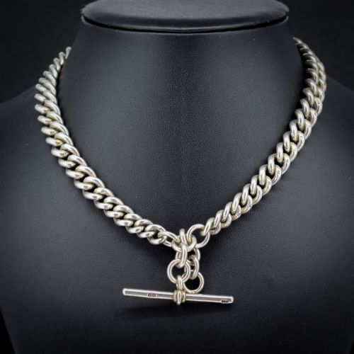 fig 1. An antique sterling silver Albert watch chain featuring heavy curb links, double swivel clasps, and a central T-bar attachment.